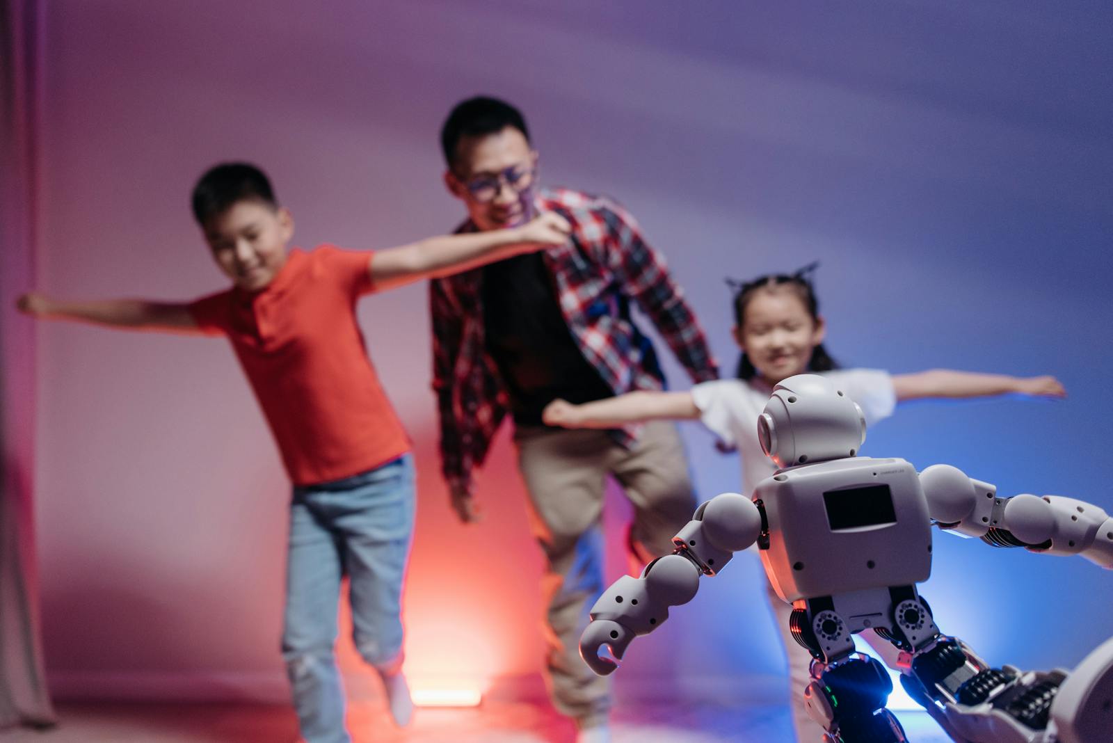 Joyful family interaction with a futuristic robot enhancing modern technology experiences. how to talk to kids about AI
