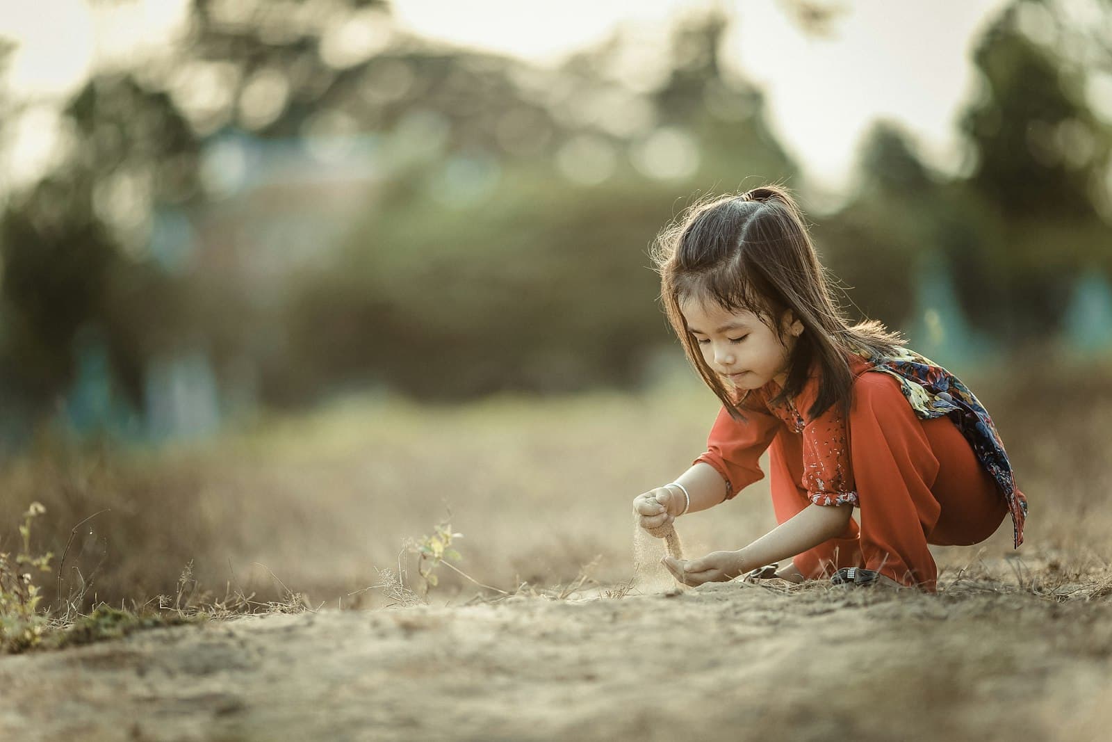 girl playing sand during daytime Raise a child who can learn anything