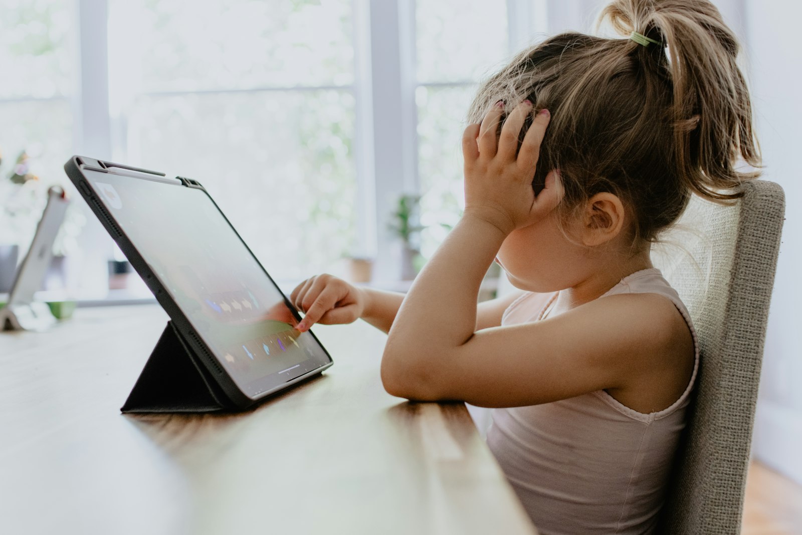 girl in white tank top using black tablet computer screen time rules